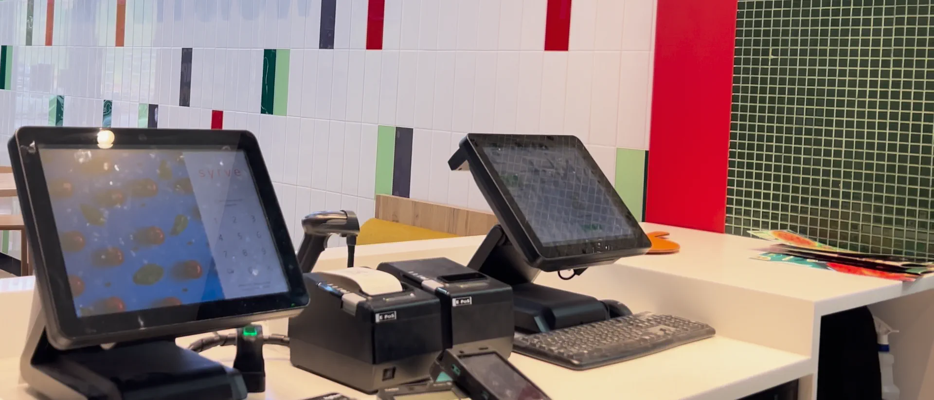 Point-of-sale terminals on the counter of a Papa John's restaurant
